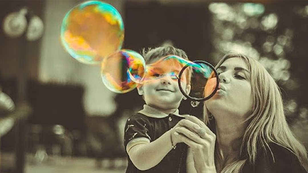 Mom Blowing Bubbles With Son