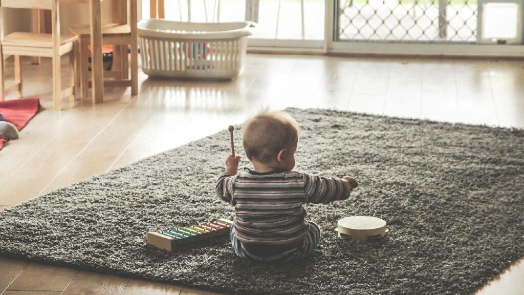 baby playing with musical toys