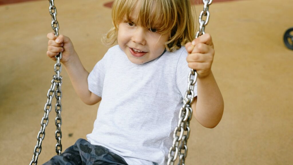 little boy swinging